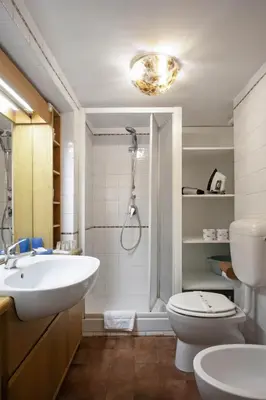 a bathroom with a sink and a toilet and a shower at Trevi Fountain Apartment in Rome