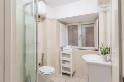 a bathroom with a toilet and a sink and a shower at GuestHost - Basic Studio - 350 m far from Fontana di Trevi in Rome