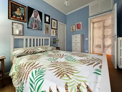 a bedroom with a bed with blue walls at Casa Gioia - Metro Garbatella in Rome