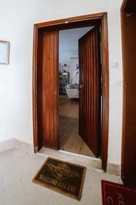 an open door into a room with a rug at Casa Gioia - Metro Garbatella in Rome