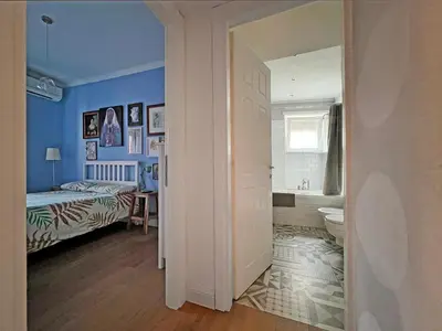 a bedroom with a bed and a bathroom at Casa Gioia - Metro Garbatella in Rome