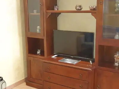a entertainment center with a flat screen tv on a dresser at A 2 passi dal cuore di Roma in Rome