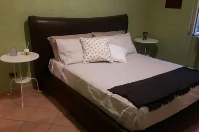 a large bed with two tables in a bedroom at A 2 passi dal cuore di Roma in Rome