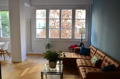 a living room with a couch and two windows at La finestra verde in Rome