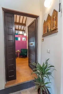a hallway with a door and a plant in a room at PgrHome Colosseo 11 in Rome