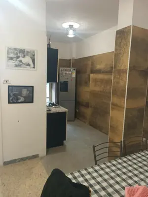 a room with a table and a kitchen with a refrigerator at Roma centro appartamento per vacanze in Rome