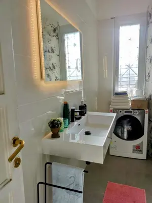 a bathroom with a white sink and a microwave at Roma centro appartamento per vacanze in Rome