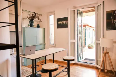 a room with a desk and stools and a window at Terrazza San Saba in Rome