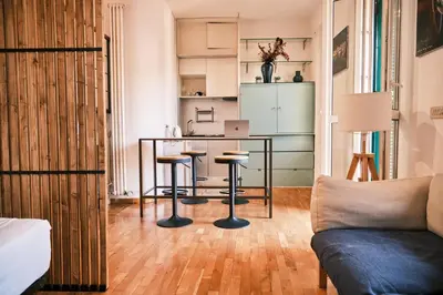 a living room with a table and stools at Terrazza San Saba in Rome