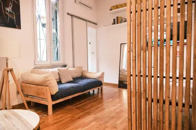 a living room with a couch and a window at Terrazza San Saba in Rome