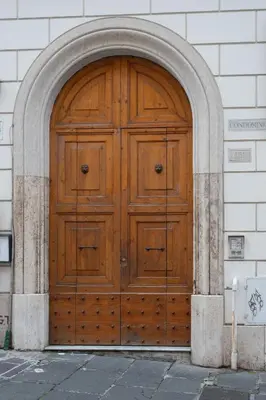 a large wooden door in a building at Nostromondo Basilica Apartment in Rome