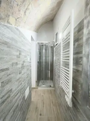 a bathroom with a walk in shower in a room at Apartment with Terrace in the Heart of Pigneto in Rome