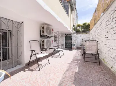 a patio with chairs and a brick wall at Apartment with Terrace in the Heart of Pigneto in Rome