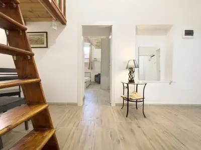 a room with a staircase and a table in it at Apartment with Terrace in the Heart of Pigneto in Rome