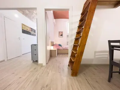 a room with a stairs leading to a bedroom at Apartment with Terrace in the Heart of Pigneto in Rome