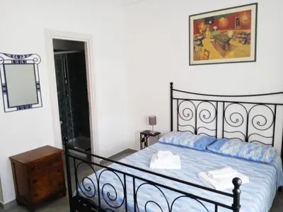 a bedroom with a black bed and a mirror at casaLucina in Rome