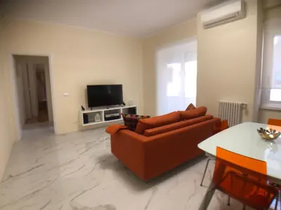 a living room with a couch and a tv at Maison Carlotta In Vatican in Rome