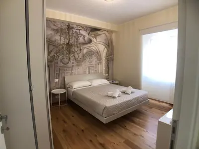 a bedroom with a bed and a painting on the wall at Maison Carlotta In Vatican in Rome