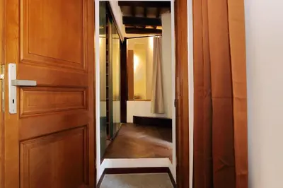 a door leading into a hallway with a mirror at YCH Elegant flat with terrace to Trastevere in Rome