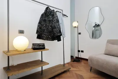 a room with a shelf and a lamp and a couch at YCH Elegant flat with terrace to Trastevere in Rome