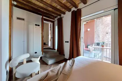 a bedroom with a bed and two chairs and a window at YCH Elegant flat with terrace to Trastevere in Rome