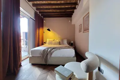 a bedroom with a bed and a large window at YCH Elegant flat with terrace to Trastevere in Rome