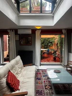 a living room with a white couch and a glass table at trastevere' s Musa in Rome
