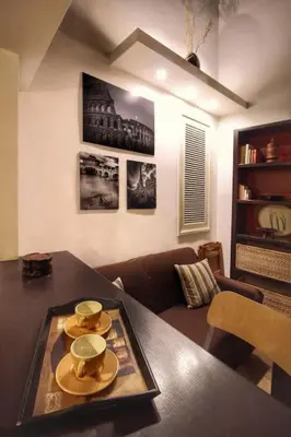 a living room with a table with plates on it at Hidden Treasure-Campo de' Fiori in Rome