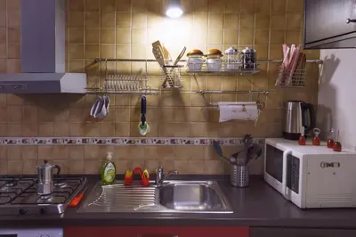 a kitchen counter with a sink and a microwave at Hidden Treasure-Campo de' Fiori in Rome
