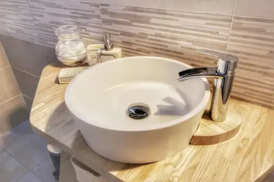 a white sink on a wooden counter in a bathroom at Hidden Treasure-Campo de' Fiori in Rome