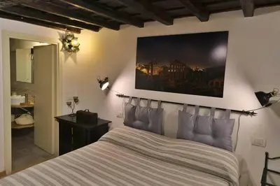a bedroom with a bed with a painting on the wall at Hidden Treasure-Campo de' Fiori in Rome