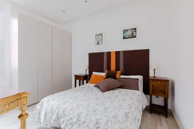 a bedroom with a large bed and a wooden table at Minerva's Place in Rome
