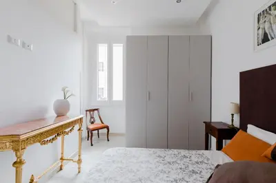 a bedroom with a bed and a dresser and a desk at Minerva's Place in Rome