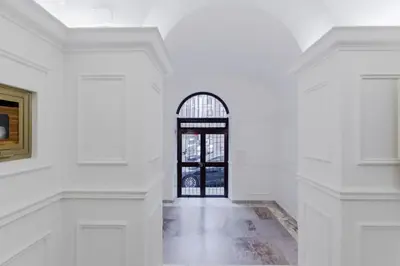 a white hallway with a door and a window at Minerva's Place in Rome
