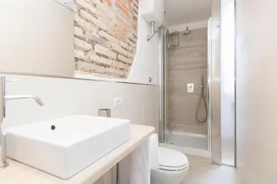 a bathroom with a sink and a toilet and a shower at Minerva's Place in Rome