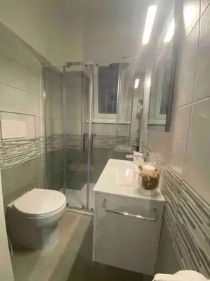a bathroom with a toilet and a shower and a sink at La Casa di Marco Polo in Rome