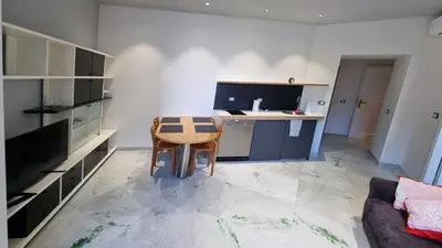 a kitchen with a table and a desk in a room at Vignola New Apartment in Rome