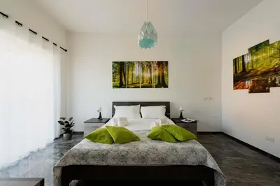 a bedroom with a bed and two paintings on the wall at Home Big Crirè at 724 in Rome