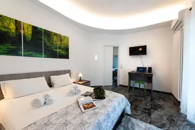 a bedroom with a large bed and a television at Home Big Crirè at 724 in Rome