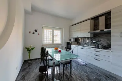a kitchen with a glass table and some chairs at Home Big Crirè at 724 in Rome