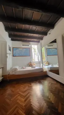 a large room with two beds and two windows at Vivaldi in Rome