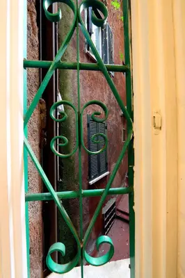 a green metal gate in front of a building at Vivaldi in Rome