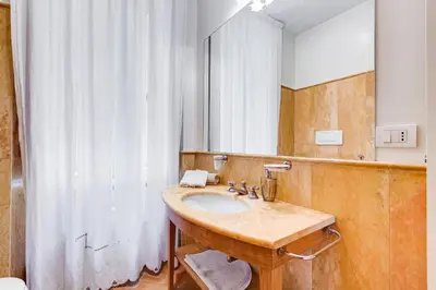a bathroom with a sink and a mirror at Pantheon Exclusive House in Rome