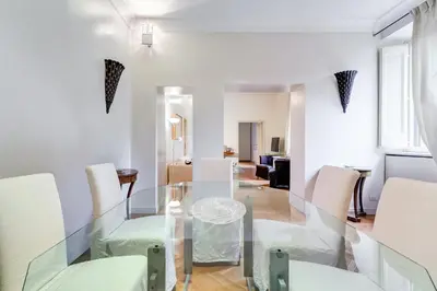 a dining room with a glass table and chairs at Pantheon Exclusive House in Rome