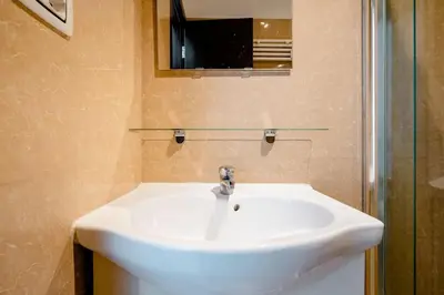 a bathroom with a white sink and a mirror at Francesco Romestay - Termini in Rome