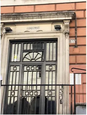 a glass door of a building with a gate at Francesco Romestay - Termini in Rome