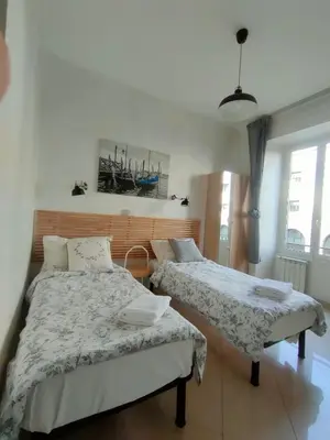 a bedroom with two beds and a window at Francesco Romestay - Termini in Rome