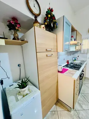 a small kitchen with a christmas tree on the wall at Monolocale San Giovanni in Rome