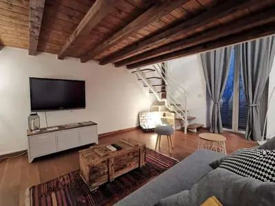 a living room with a couch and a tv at La Dimora Dante in Rome