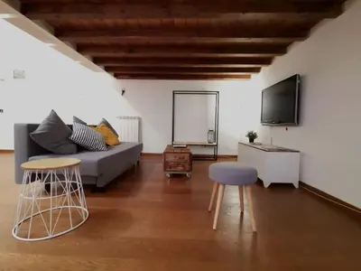 a living room with a couch and a tv at La Dimora Dante in Rome